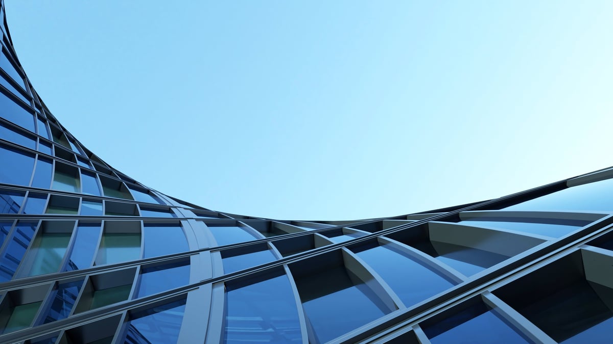 Modern commercial office building with a curved glass facade